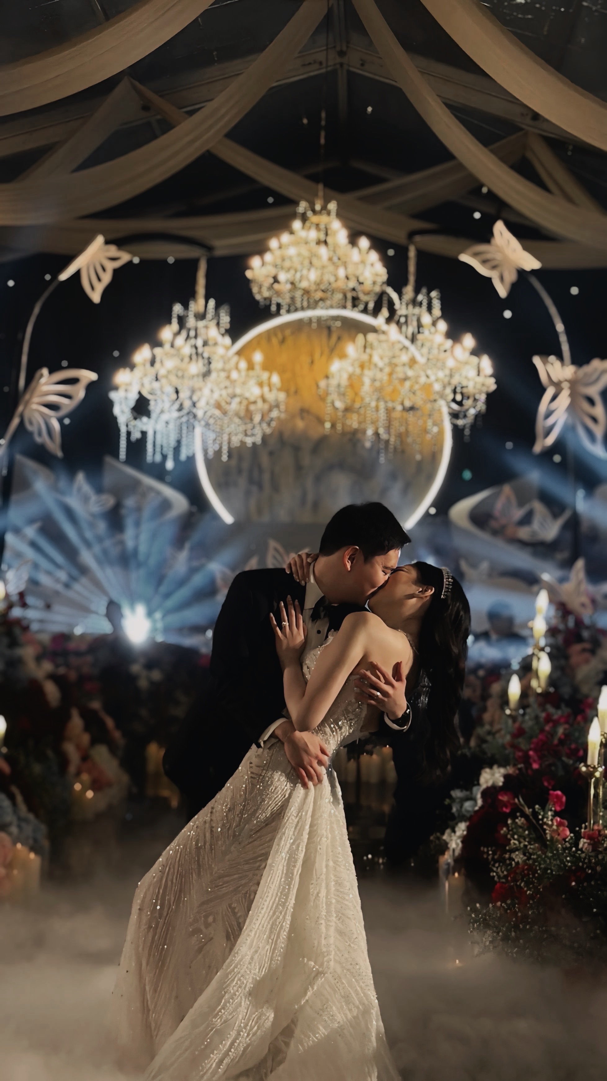 Couple's cinematic first dance beneath grand chandeliers