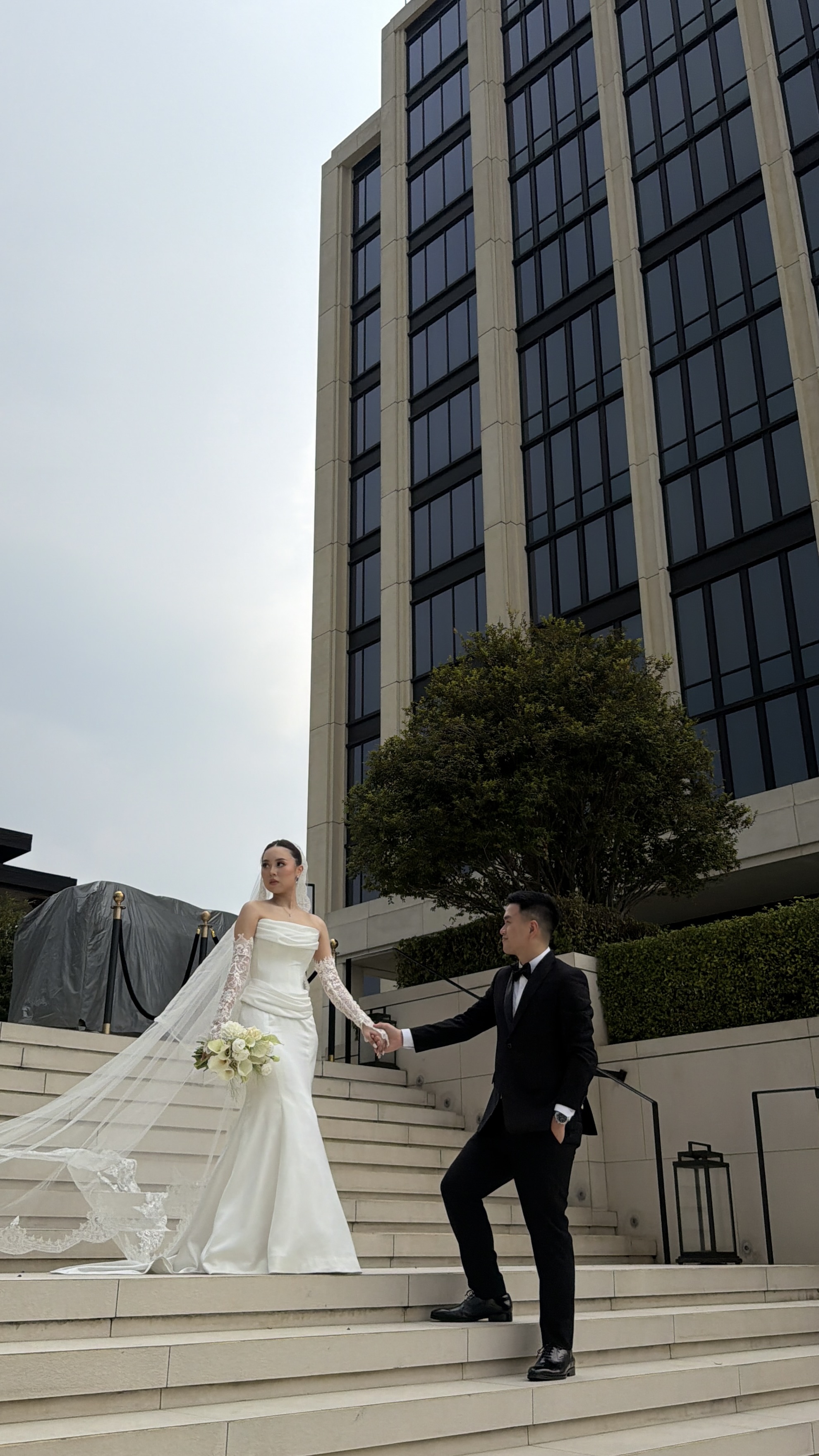 Couple hand in hand on grand hotel steps