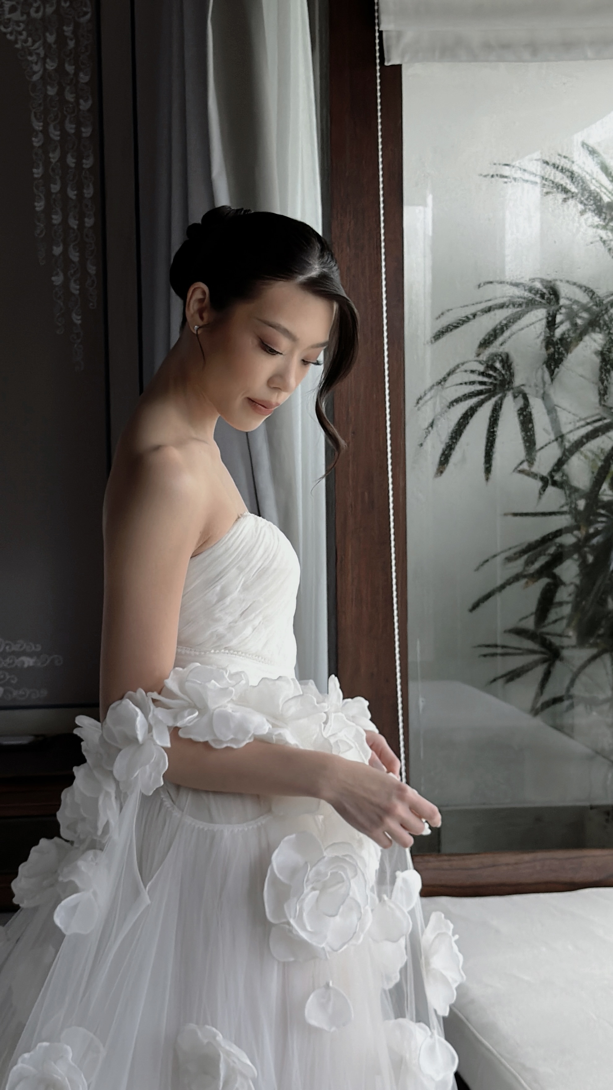 Bride in a floral gown in soft window light